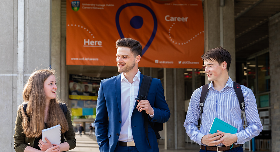 Three UCD students walking.